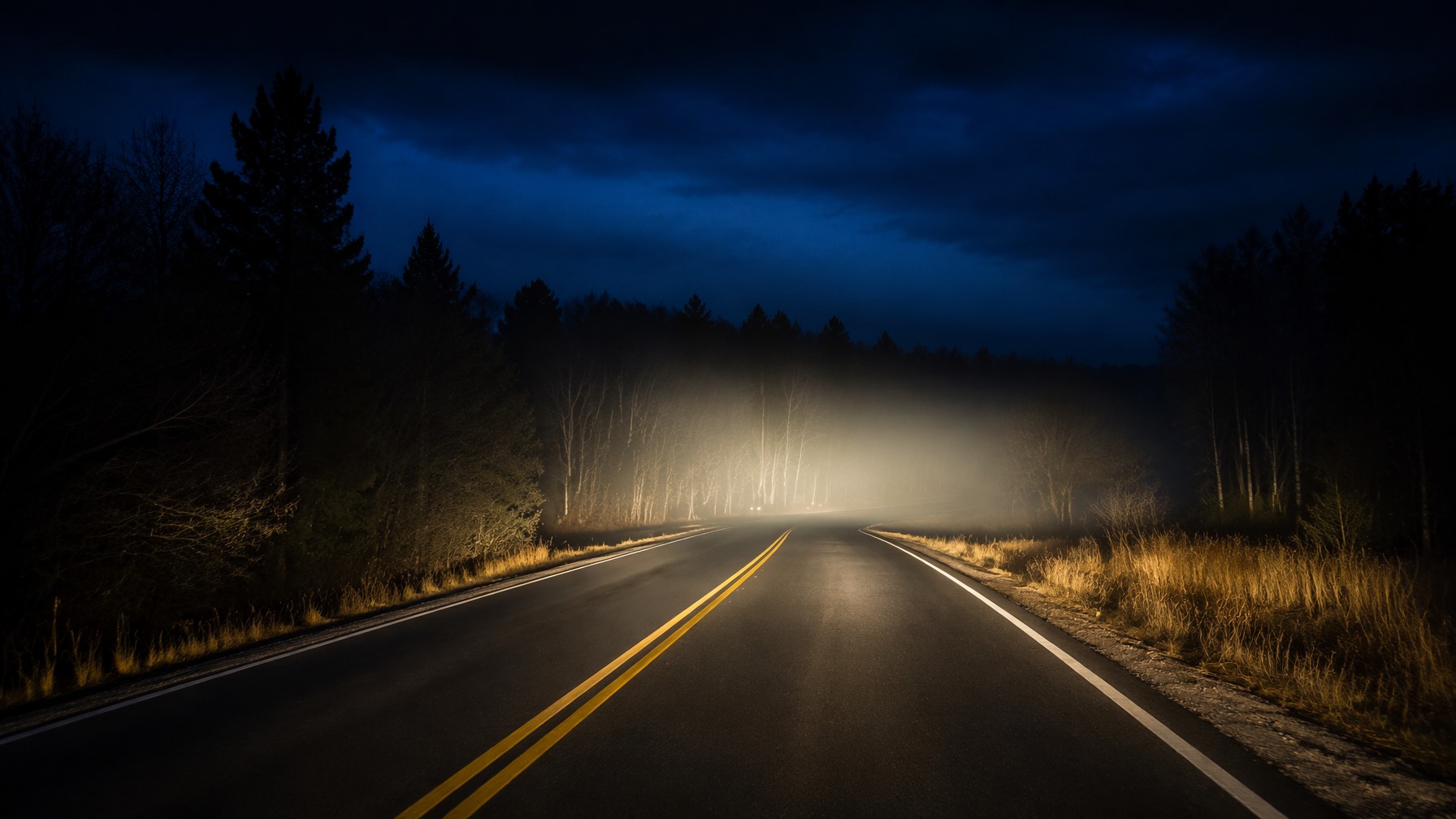 car headlights at night on country road